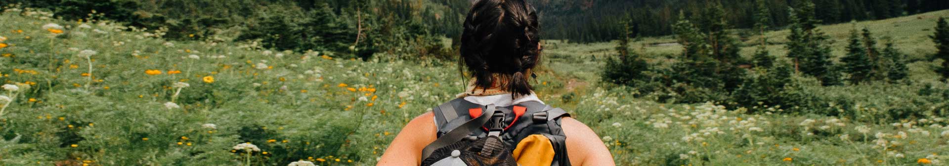 A person walking away from the camera with a backpack